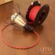 Lampe baladeuse Kenza - câble torsadé rouge, douille porcelaine et cage US
