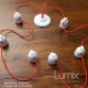 Porcelain garland in suspension twisted textile cable vintage style